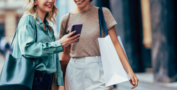 istock Two Women Enjoying a Friendly Chat While Shopping in City 2150200203
