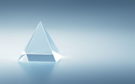 3d Render Crystal Glass Pyramid Shape on Blue Soft Background (Close-up)