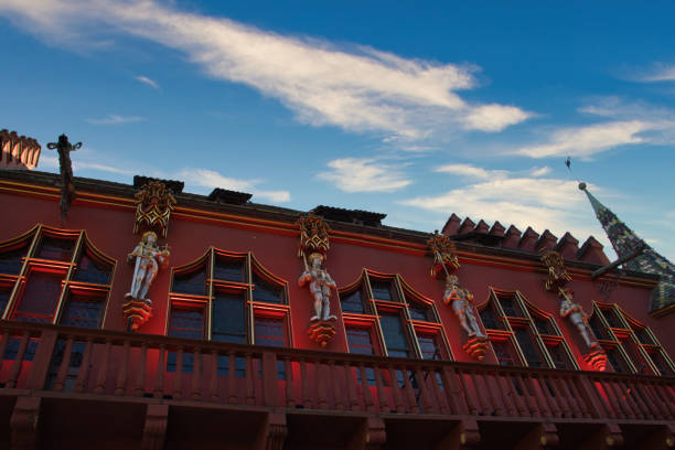 Freiburg, Germany: August, 18 2023: Red building called Grand Warehouse on the Munsterplatz, Freiburg. It has 4 statues depicting Maximilian I, Philip the Handsome, Charles V and his brother Ferdinand I.