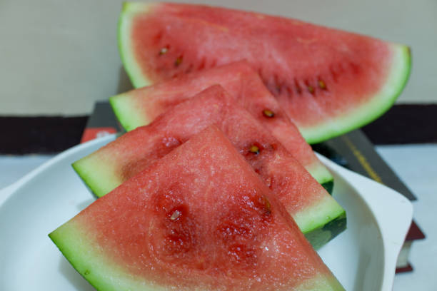 istock Red watermelon cut into triangles, on a white plate 2150205847