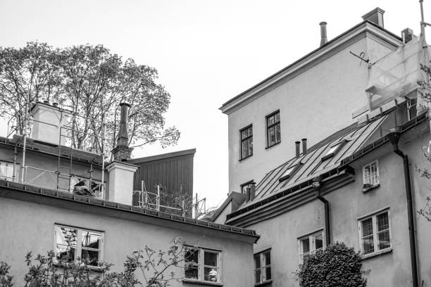 Low angle view of buildings against sky in black and white