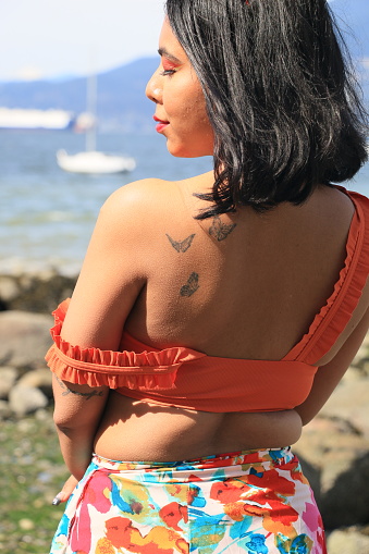 A woman getting a henna tattoo at a small studio.