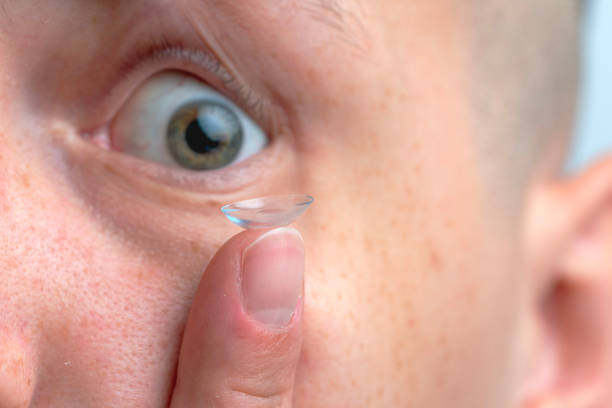 Man Holding Contact Lens On Finger.
