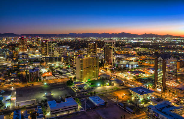 Midtown Phoenix Aerial At Sunset Midtown Phoenix aerial at sunset, with a sun painted sunset sky and the South Mountains mountain range and Downtown Phoenix in the background. phoenix stone stock pictures, royalty-free photos & images