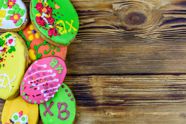 Easter cookies in plate on wooden background. Top view
