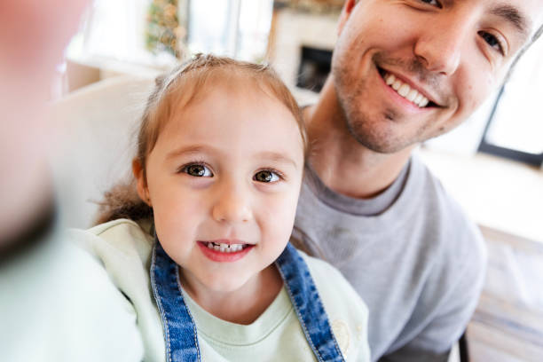 istock Young daughter holds camera to take a selfie 2150223838