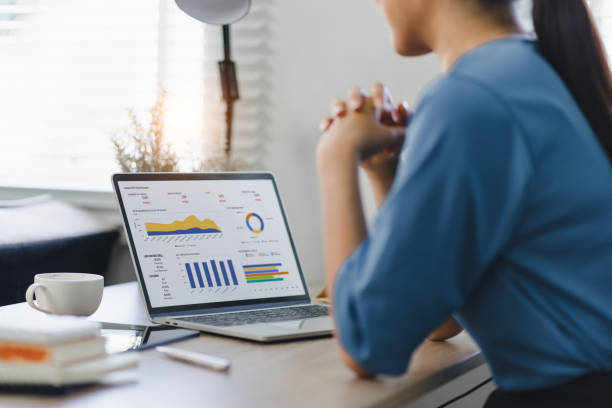istock Businesswoman or accountant analyzing data charts, graphs, and dashboard on laptop screen to increase sales and revenue. Business data analytics concept. 2150226385
