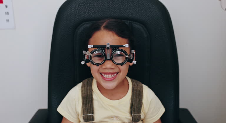 Optometry, optician and portrait of child with frame for testing vision, sight and glasses for eyes. Healthcare, medical equipment and young patient for prescription lens for assessment in clinic