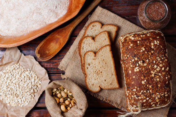 istock whole wheat bread with grains and seeds sliced on wooden table 2150227836