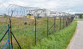Barbed wire fence. Razor wire. Restricted area. Airport protection.