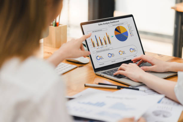 istock Professional working intensively on a financial analysis with colorful charts and data spreadsheets displayed on a laptop. 2150230413