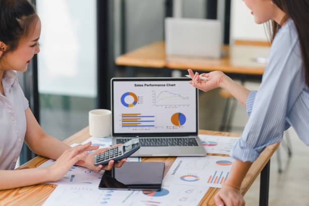 istock Two businesspeople or an accountant team are analyzing data charts, graphs, and a dashboard on a laptop screen in order to prepare a statistical report and discuss financial data in an office. 2150230428