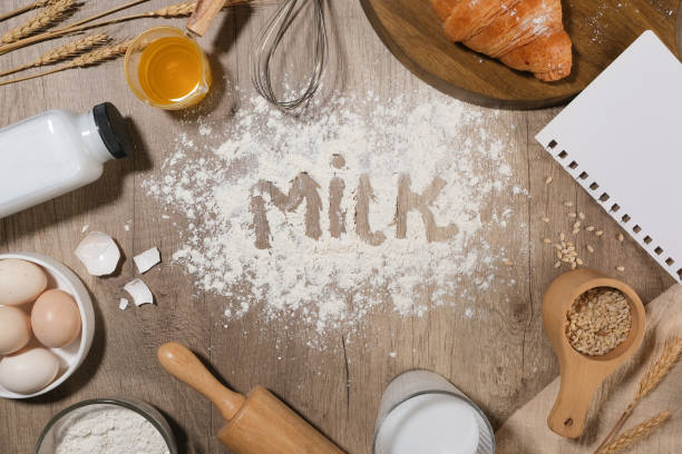 istock Baking cake with different dough recipe ingredients, flat lay on wooden kitchen background. Blank space in center for adding text or displaying product 2150232922