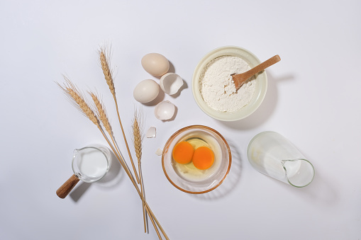 Kitchen background of cooking concepts, flay lay ingredients with egg, flour and milk. Photo for advertising product with blank space, top view