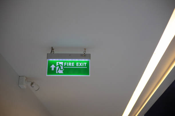 istock Green signs indicating fire exits installed in the building. except copy space 2150233774
