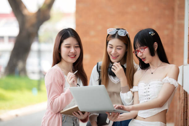 istock Asian young campus student enjoy learn study and reading books together. Friendship and Education concept. Campus school and university. Happiness and funny of learning in college 2150234568