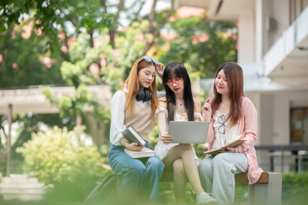 istock Asian young campus student enjoy learn study and reading books together. Friendship and Education concept. Campus school and university. Happiness and funny of learning in college 2150234573