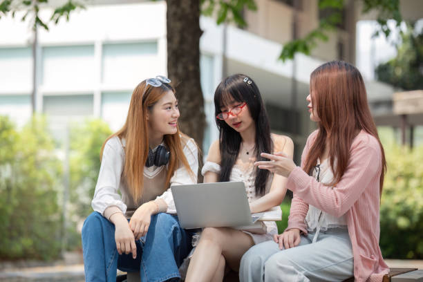 istock Asian young campus student enjoy learn study and reading books together. Friendship and Education concept. Campus school and university. Happiness and funny of learning in college 2150234582