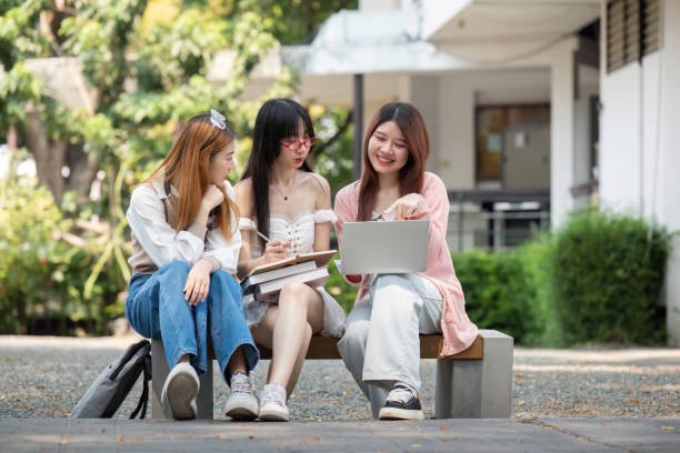 istock Asian young campus student enjoy learn study and reading books together. Friendship and Education concept. Campus school and university. Happiness and funny of learning in college 2150234588