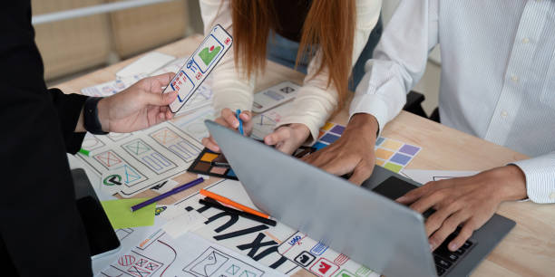 istock Brainstorm team of creative web graphic designer planning. Creative designers present ux ui to team. Designers team working meeting in office 2150235003