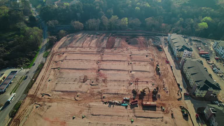 Huge construction site for residential home complex in South Atlanta, Georgia, USA. Telescopic Boom Lift, scissor lift, dirty parking lot.
