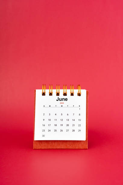 istock June 2024 white mini desk calendar on red background. 2150238811