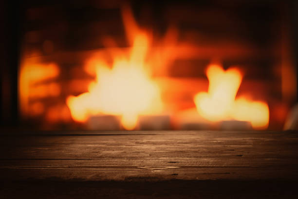 istock empty dark brown wooden tabletop for product display on blurred wood burning fireplace background 2150245399