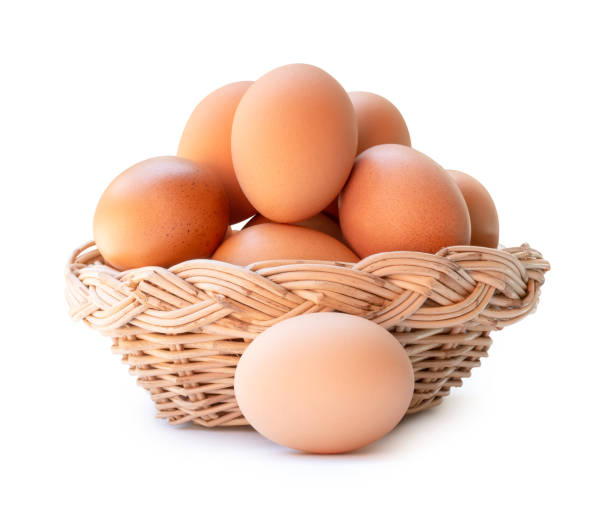 istock Front view of fresh brown chicken eggs in stack in wicker basket isolated on white background with clipping path 2150247019