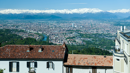 View of the city of Turin surrounded by snow-capped mountains, taken from the Basilica of Superga