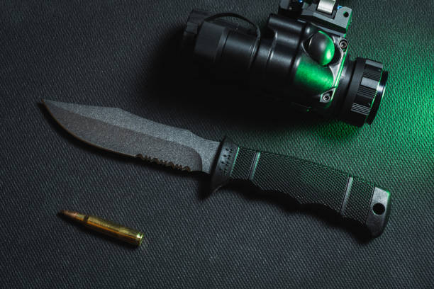 istock Tactical knife with a fixed blade, gt14 night vision device and 5.56x45mm cartridge. 2150249310