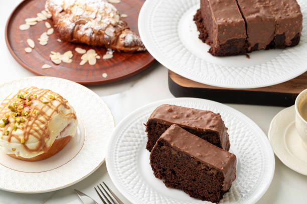 Homemade desserts sponge cake and cinnamon bun on table close up