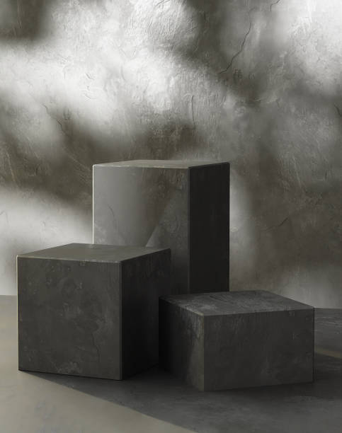 istock Three modern black cuboid stone podium, geometric pedestal on gray counter 2150251643