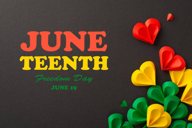 istock Emancipation celebration: hearts in red, green, yellow on black, symbolizing Juneteenth's end of slavery. Top view photo with text inscription on it 2150252316