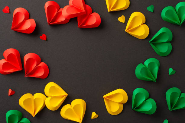istock Juneteenth recognition: hearts in red, green, yellow on black surface, marking liberation from slavery. Top view shot allows for social text or advert placement 2150252323