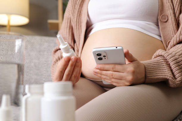 istock Young pregnant woman prepare using smartphone for checking clinic app illness screen on online advice doctor remote exam telemedicine reading online instruction 2150253477