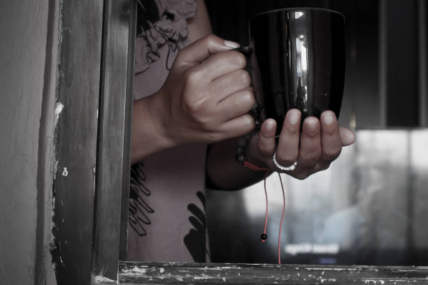 Hand holding a mug containing a drink welcoming the morning