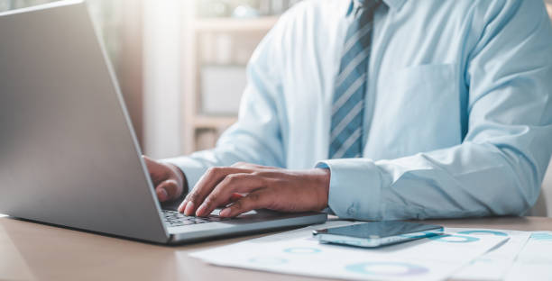istock businessman typing keyboard with a pie chart document showing company financial information. 2150254406