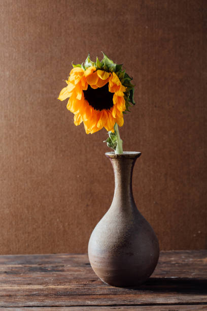 istock Sunflowers in a vase on a wooden table 2150255209