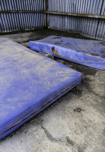 Detail of mattresses thrown in the trash, pollution