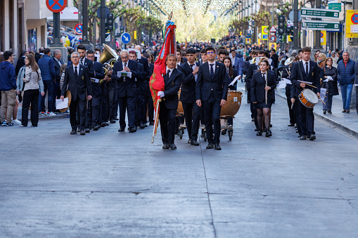 04-19-2024: Music band parading with its director in front at the pasodoble festival prior to singing the festival anthem of Alcoy, Spain