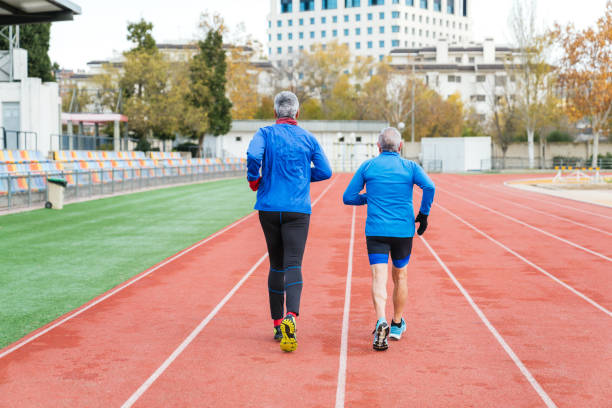 istock Senior Caucasian Runners Exercising Together on Track 2150259236