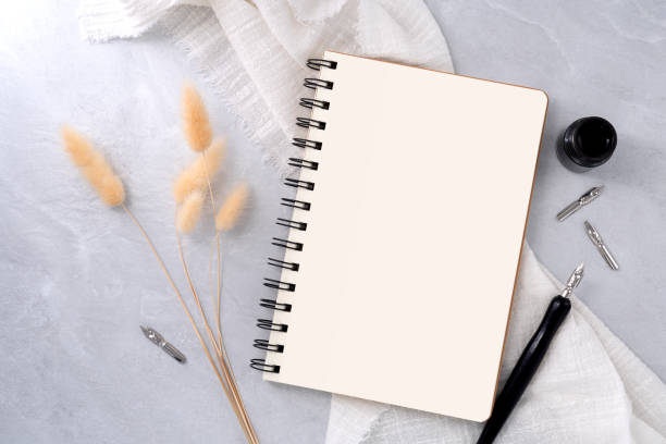 istock Blank book with dip pen on stone texture background. Writer workplace concept. 2150259673