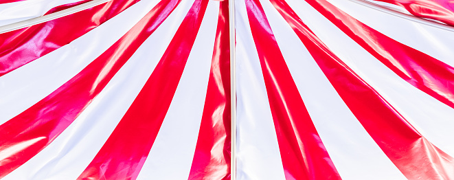 Circus tent background. Colorful design, striped white and red, retro entertainment.