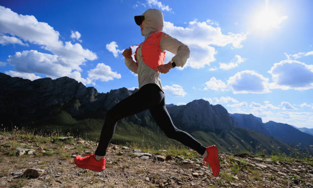 istock Woman ultramarathon runne running at mountain top 2150261341