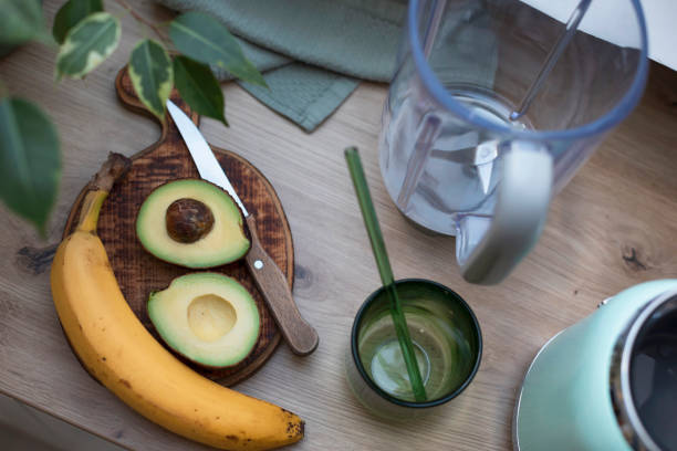 Preparation of healthy smoothie at home. Avocado, banana. Self-care. Health and wellbeing.
