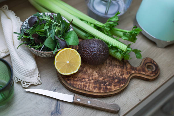 lime and avocado close up in wooden board