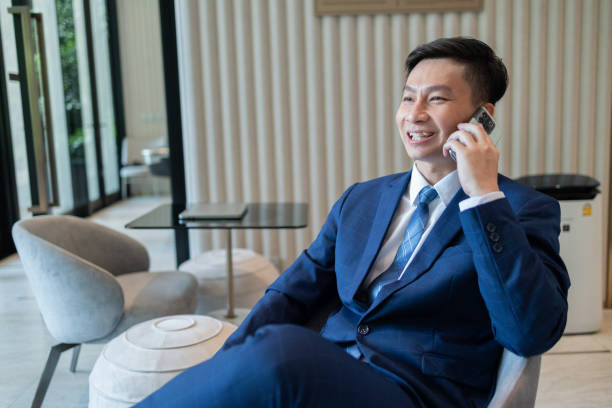 istock Businessman Checking Phone in Modern Lounge Area 2150262795