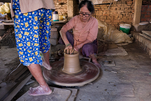 Vietnamese women working in a workshop, in Hoi An city, Vietnam. Hoi An is situated on the east coast of Vietnam. Its old town is a UNESCO World Heritage Site because of its historical buildings.