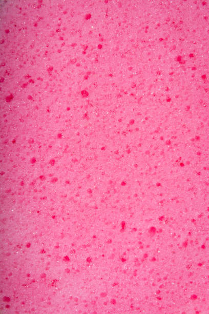 Pink sponge with porous texture background. Copy space, no people