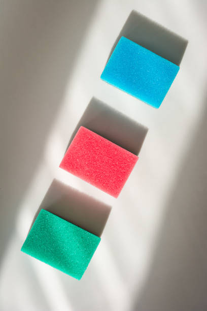High angle view of colored sponges on sunny background